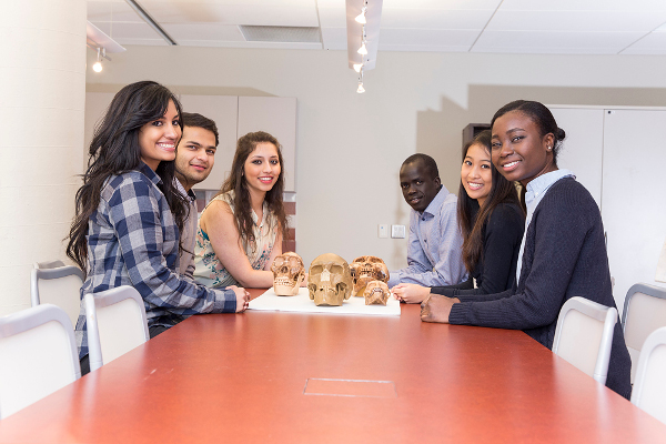 Bio Program students smiling around a table