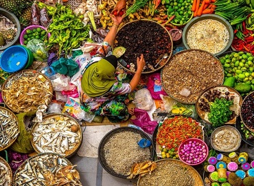 Woman with baskets of food for sale