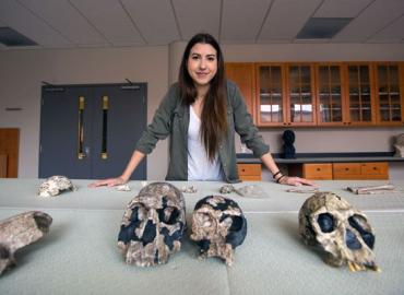 Undergraduate student Klara Komza with skulls in a laboratory